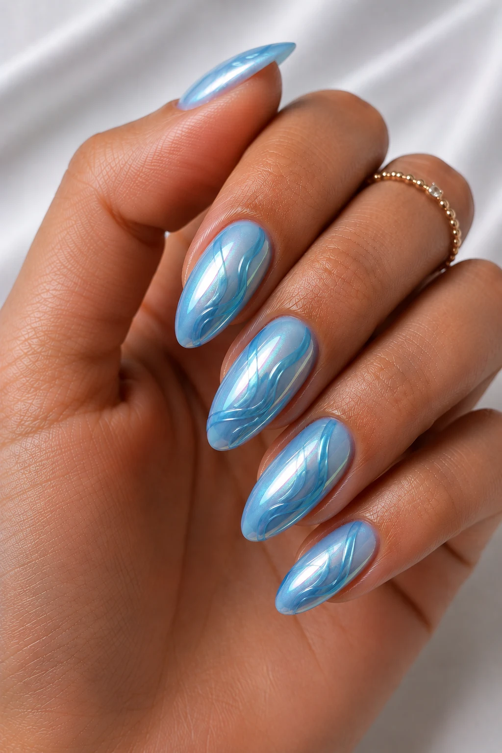 Ocean Chrome Waves — cool summer nails almond style outfit, worn by a stylish woman