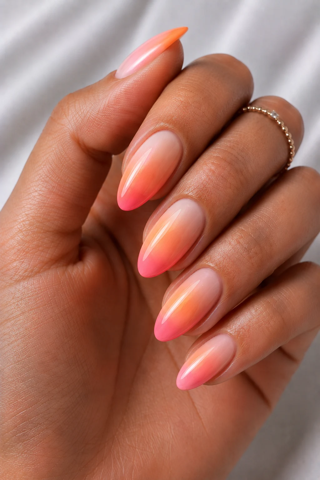 Sunset Sorbet Ombre — cool summer nails almond style outfit, worn by a stylish woman