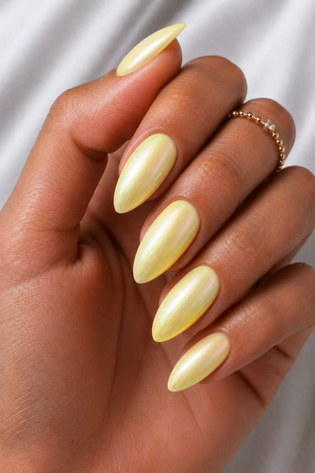 Lemonade Glazed Almond Nails — cool summer nails almond style outfit, worn by a stylish woman