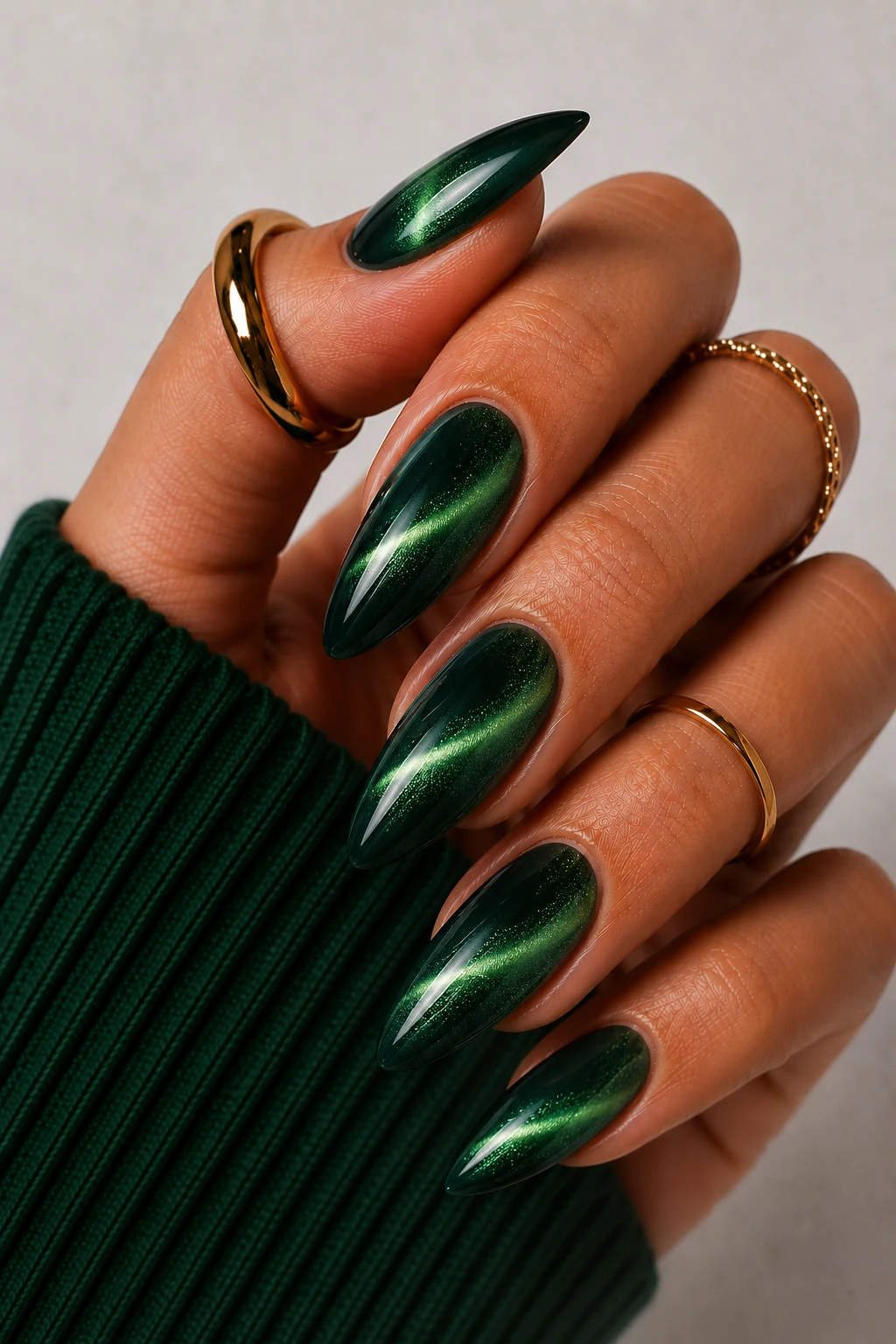 Dark Green Chrome Cat-Eye Magic — dark green nail ideas style outfit, worn by a stylish woman
