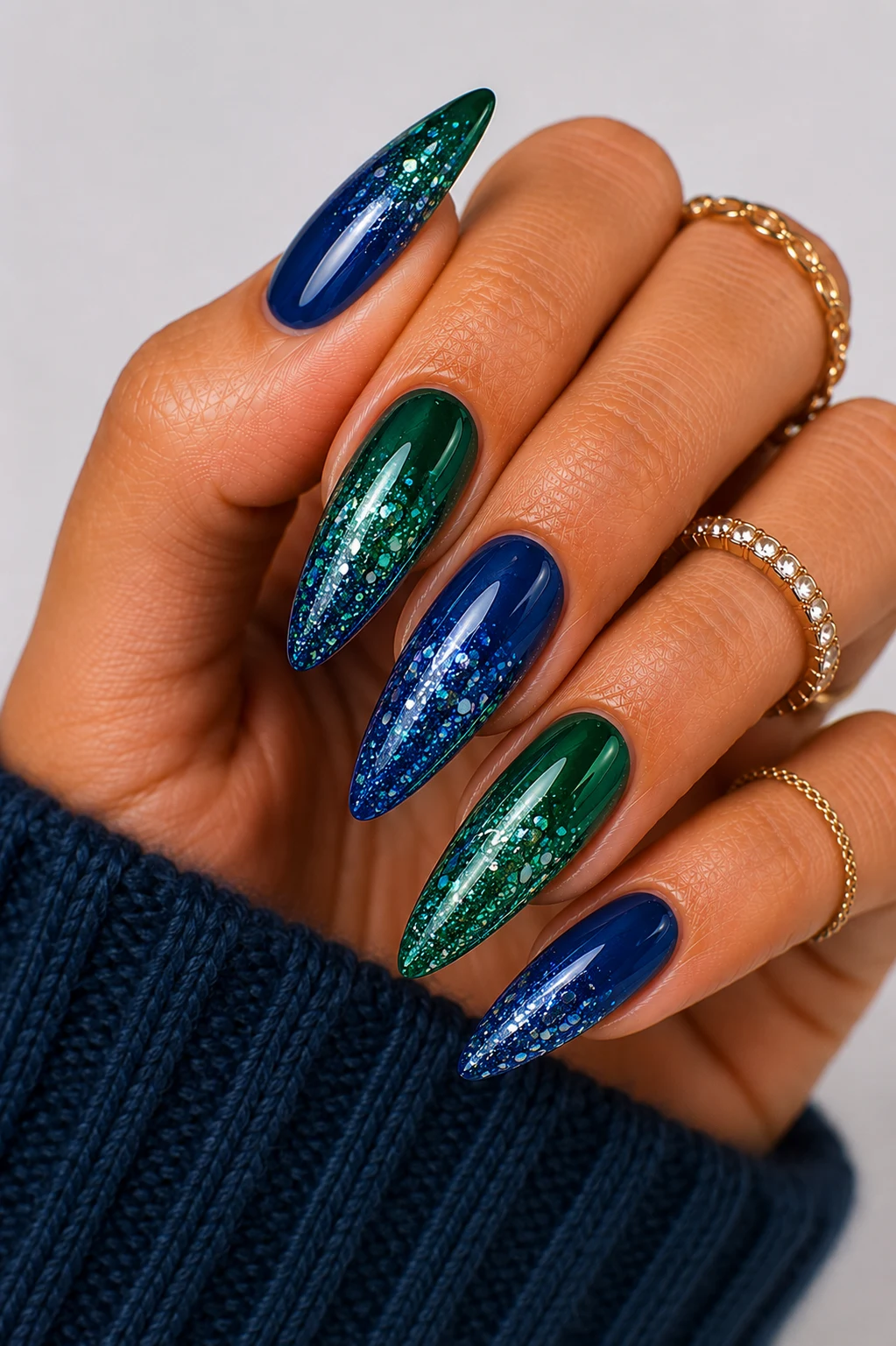 Glittering Jewel-Tone Glam — green and blue nail ideas style outfit, worn by a stylish woman